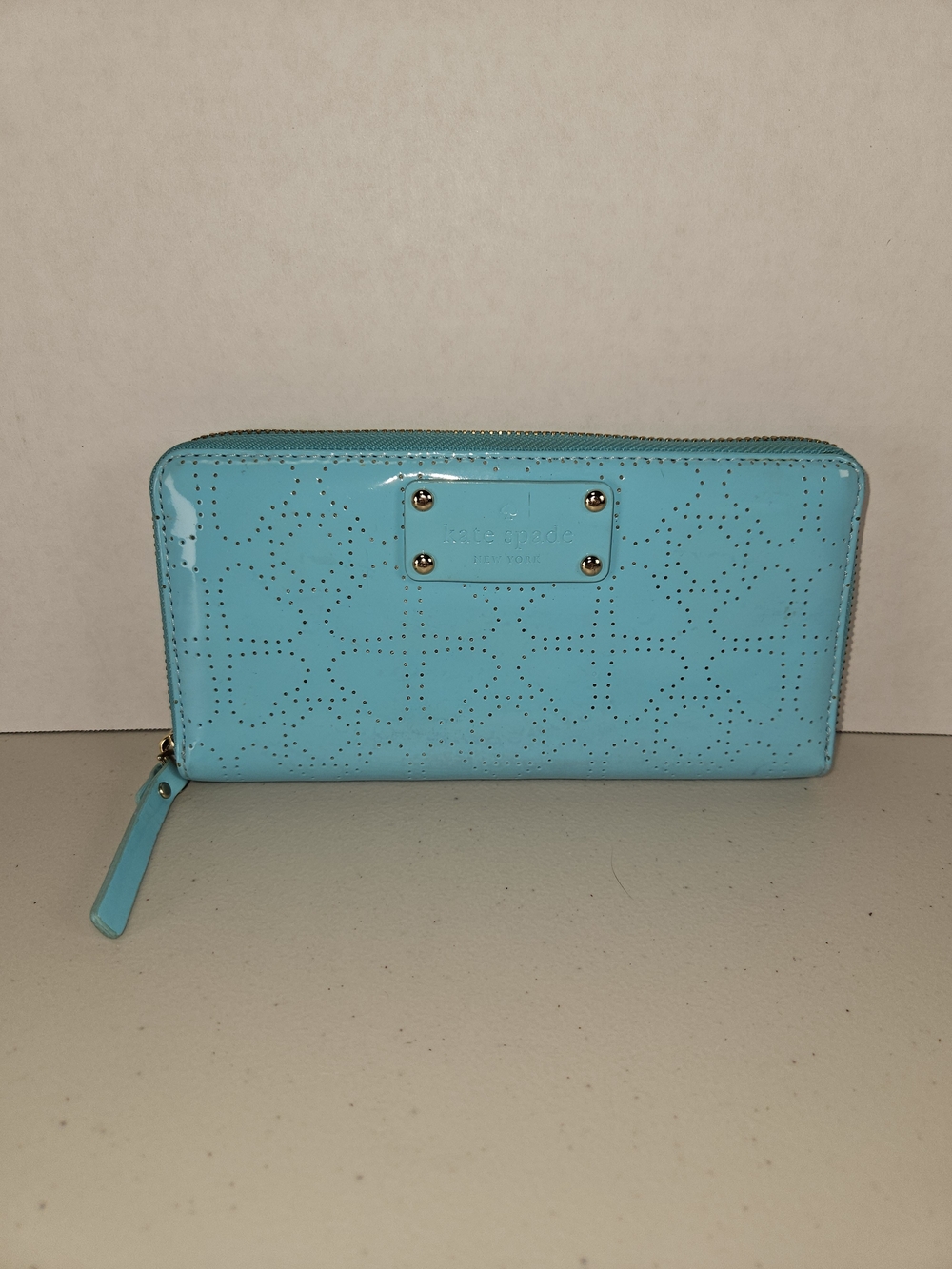 kate spade glossy perforated zip-around wallet in turquoise blue